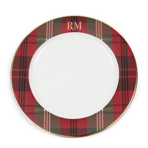 Talerz obiadowy Classic Tartan Riviera Maison z białym wnętrzem i wzorem w czerwono-zieloną kratę na krawędzi. Złota obręcz oraz logo RM na górze talerza. Ujęcie frontalne, talerz leży na płaskiej powierzchni.