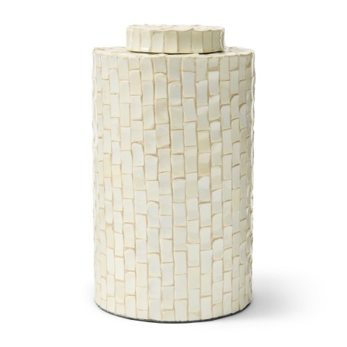 Pojemnik Mustique L Riviera Maison w kształcie cylindra, pokryty teksturowaną powierzchnią w odcieniach jasnego beżu. Posiada dopasowaną pokrywkę, stojący, elegancki design, idealny do dekoracji wnętrz lub przechowywania drobiazgów.