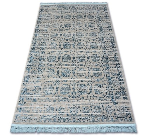 Dywan Tebanny w kolorze szaro-niebieskim o wymiarach 160x230 cm, z delikatnym wzorem roślinnym. Produkt leży na płasko, z frędzlami na krótszych krawędziach, na jasnym tle. Tekstura jest gładka, co podkreśla elegancki wygląd.