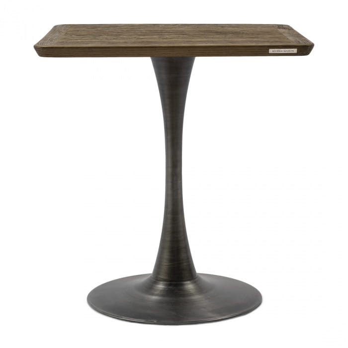 Stolik Bistro Montpellier 70x70 cm o prostokątnym blacie w kolorze ciemnego drewna i metalowej, matowej podstawie w kolorze grafitowym. Produkt stoi na podłodze, frontowy kąt ujęcia ukazuje jego minimalistyczny design.