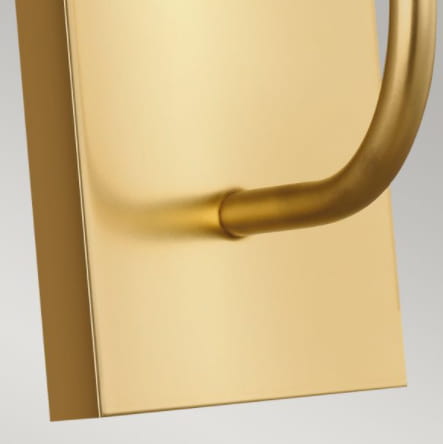 Kinkiet Brioni I w kolorze mosiądzu, o wymiarach 10x36 cm. Frontalnie widoczny, z metalowym, zaokrąglonym uchwytem. Gładka powierzchnia z matowym wykończeniem, brak widocznych napisów czy dekoracji. Produkt wiszący, idealny do nowoczesnych wnętrz.
