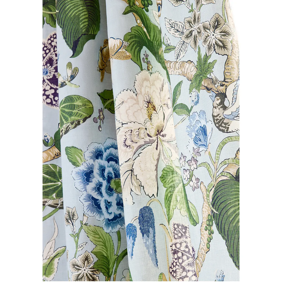 Tapeta Thibaut Anna French HILL GARDEN w beżowo-zielonej kolorystyce. Motywy kwiatowe na błękitnym tle, z widocznymi detalami liści i gałązek. Produkt rozłożony, zbliżony kąt ujęcia, ukazujący wzory i teksturę materiału.